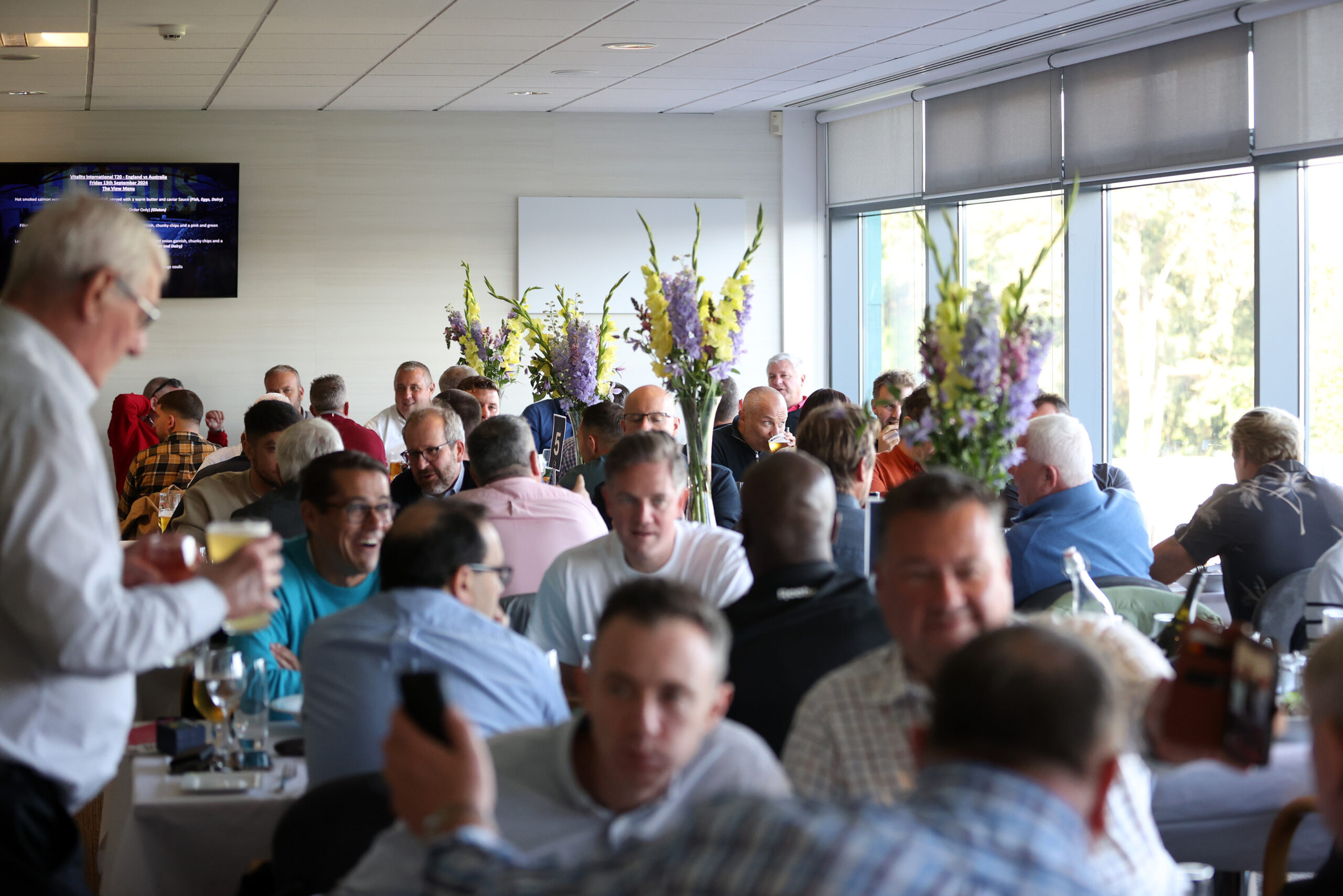 Corporate box at Sophia Gardens filled with people and flowers